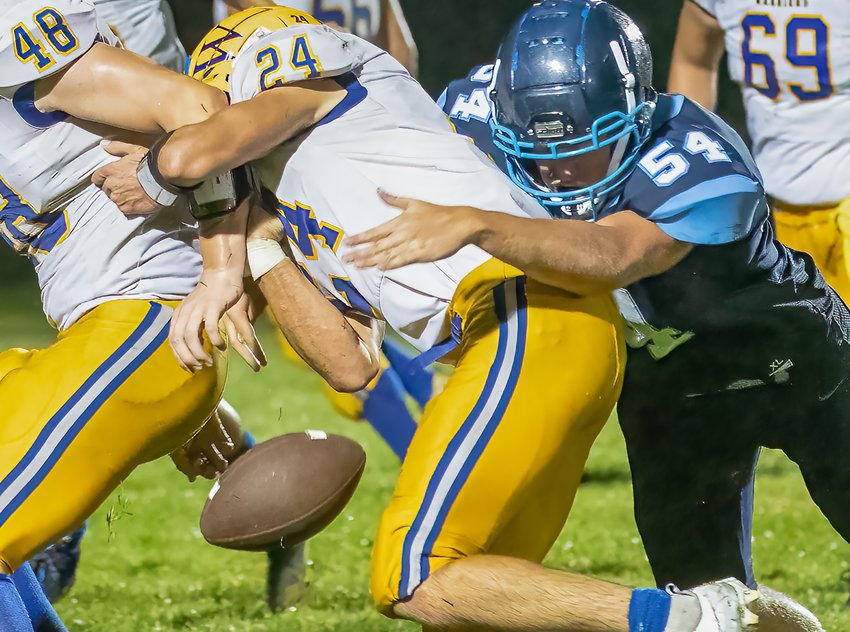 The Grizzlies&rsquo; Noah Westman forces a Deer River ball handler to fumble during action last Friday at North Woods.