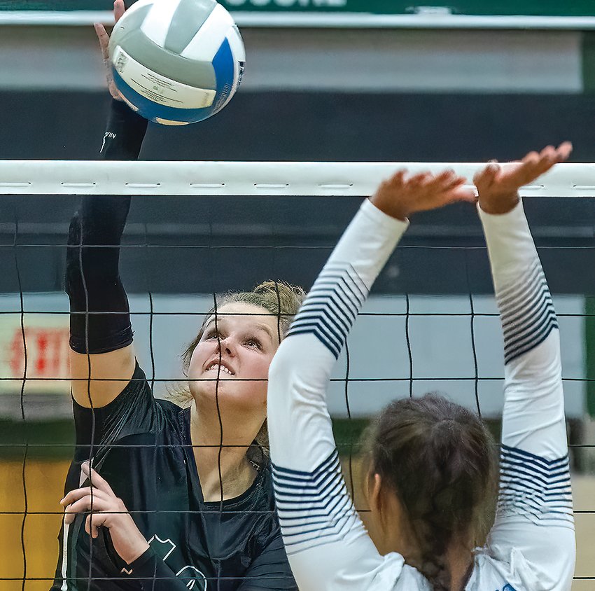 Else Bee, of Northeast Range goes up for a kill while the Grizzlies&rsquo;  Hannah Kinsey tries to block.