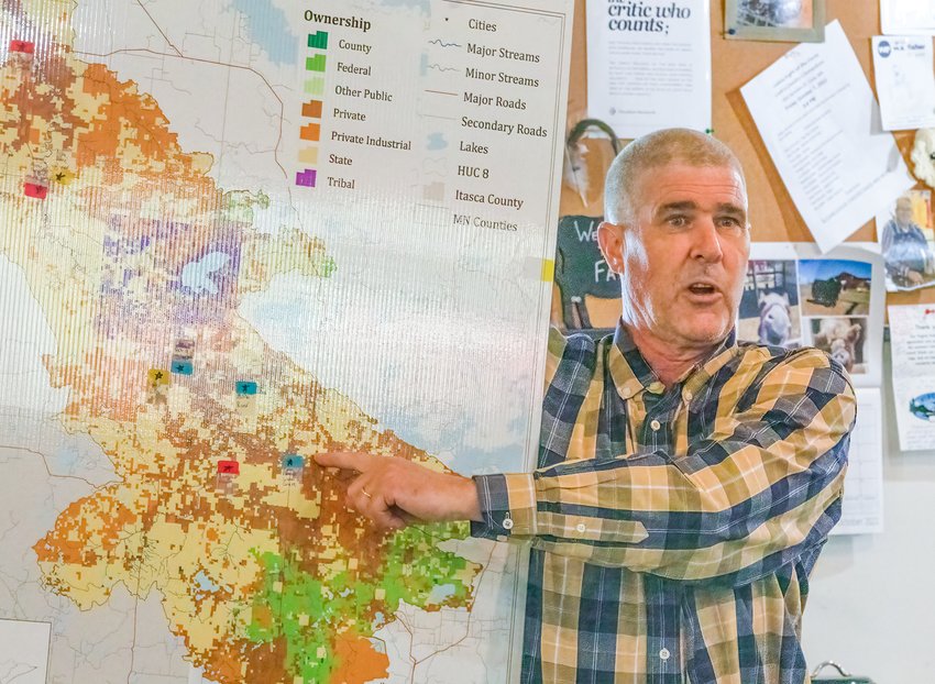 Project Coordinator Mike Jackson displays a map of the Little Fork River Watershed to illustrate aspects of a sediment and soil sampling project.