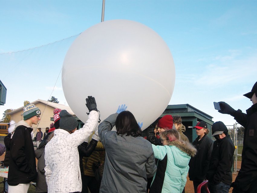 Students work together to steady Timberwolves 5 weather balloon just before launch.