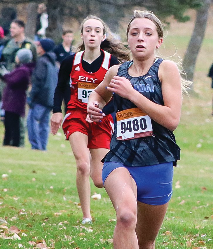 Evelyn Brodeen of North Woods, running for South Ridge, comes into the finish just ahead of Ely&rsquo;s Molly Brophy. Brodeen and Brophy finished first and   second in the Section 7A   finals last Thursday to qualify for the state meet.