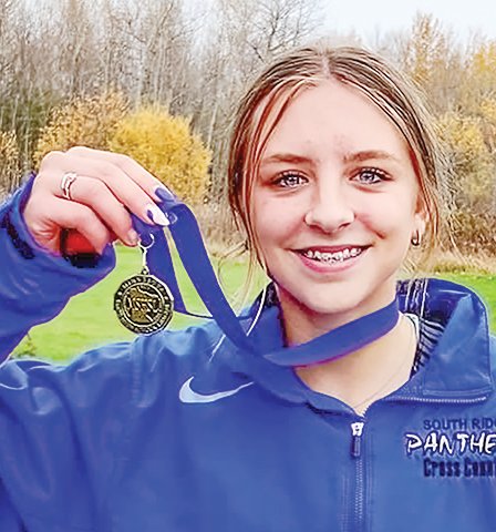 North Woods' Evelyn Brodeen is all smiles after winning the Section 7A cross country meet championship.