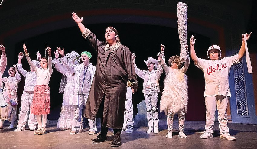 Uncle Fester, played by Ruby Milton,   dances with a chorus line of ghosts during a dress rehearsel of the Addams Family last Sunday. Ely High School performers will   present a school version of the Broadway   production this Friday, Saturday, and Sunday   in Washington Auditorium.