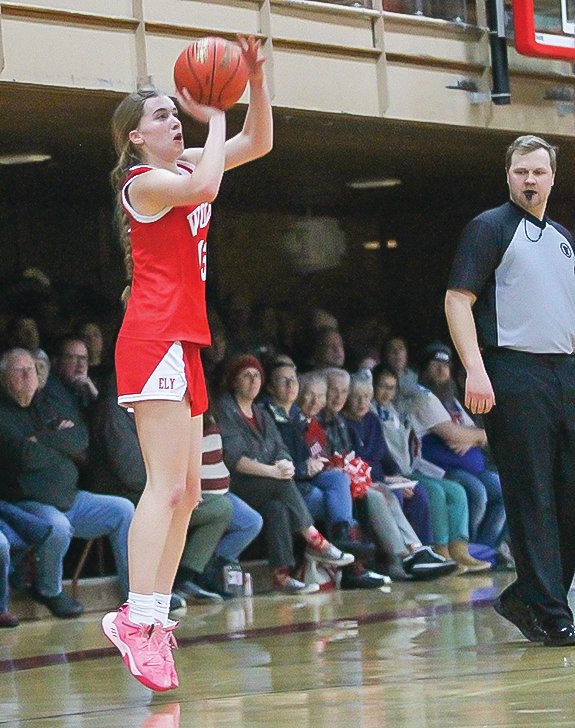 A referee closely eyes the feet of Ely&rsquo;s Hannah Penke as she shoots a three-pointer during Ely&rsquo;s Friday night home contests with South Ridge. Penke led the Wolves with 31 points on the night.