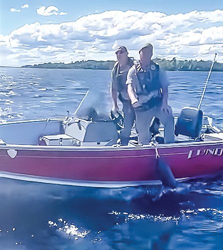 Park rangers Steve Pederson and Ryan Houghton on Lake Kabetogama shortly before boarding a boat being operated by Justin Ebel.