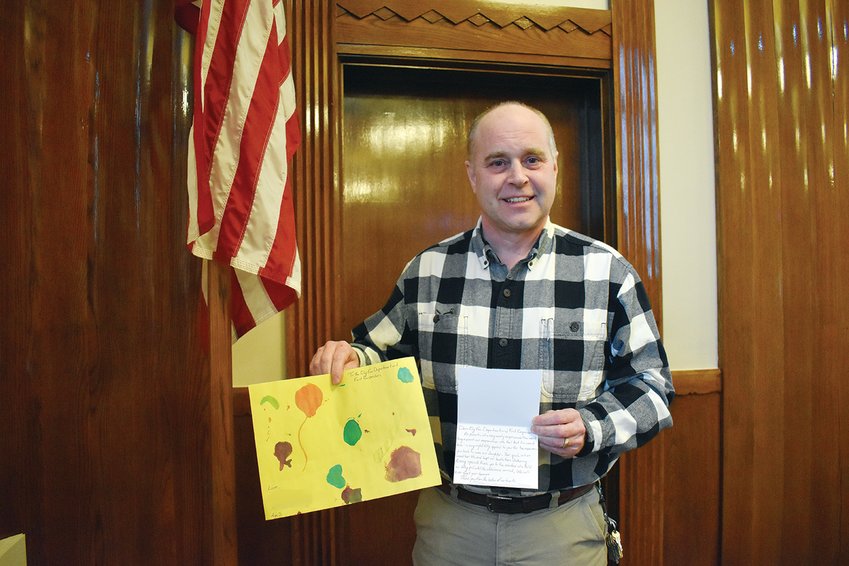 Ely Fire Chief David Marshall   displays the thank you note from the three-year-old&rsquo;s family and the thank you card drawn by the child   herself, which they sent to the first responders.