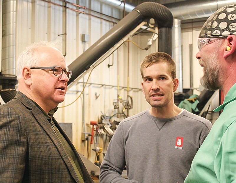 Gov. Tim Walz talks to Todd Petersen, of Lake Vermilion, one of the workers at Lamppa Manufacturing, along with Garrett Lamppa, who has recently taken the reins at the family business.