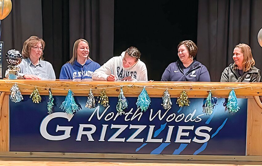 Joining Kinsey  onstage as she signs her letter of intent are, from left, her  grandmother, Brenda Flack, mother, Sarah Flack, Grizzlies Head Coach Liz Cheney, and assistant coach Becca Bundy.