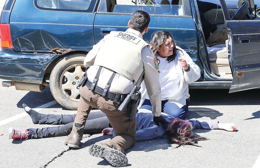 A mother reacts to the severe injury of her daughter in a mock car crash staged this week in Soudan.