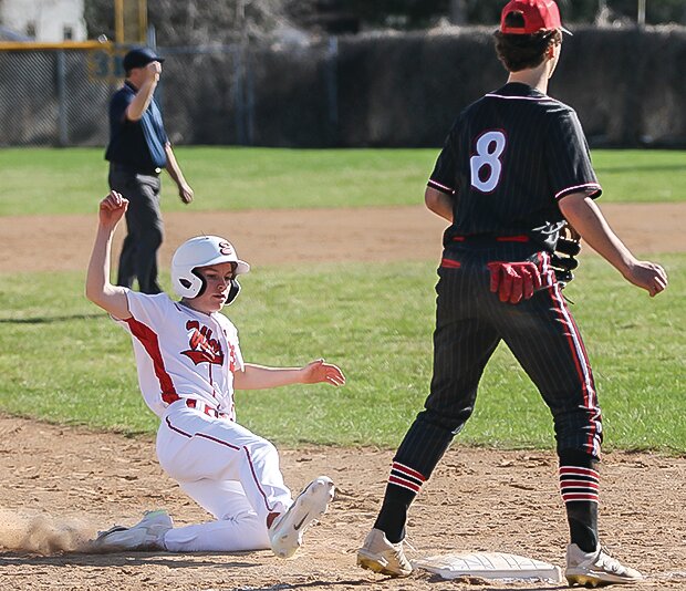Ely's Jack Davies executes a slide.
