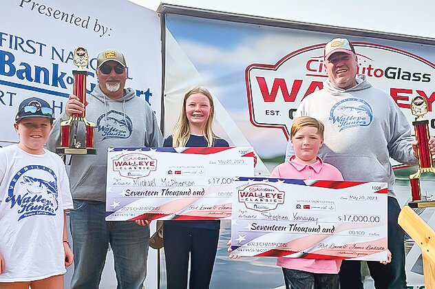 Steve   Krasaway, right,  and his fishing partner Mike McPherson, along with Krasaway&rsquo;s kids Annabelle, Ashley, and Leo, pose for a photo with their trophies and mock checks.
