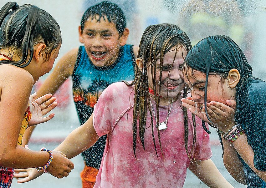 Kids dance gleefully in the overspray from Friday&rsquo;s firefighters challenge.