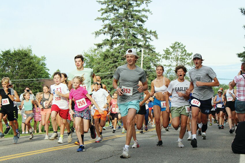Runners look fresh and eager as they take off from the starting line during the 5K portion of the Vermilion Run held July 4.