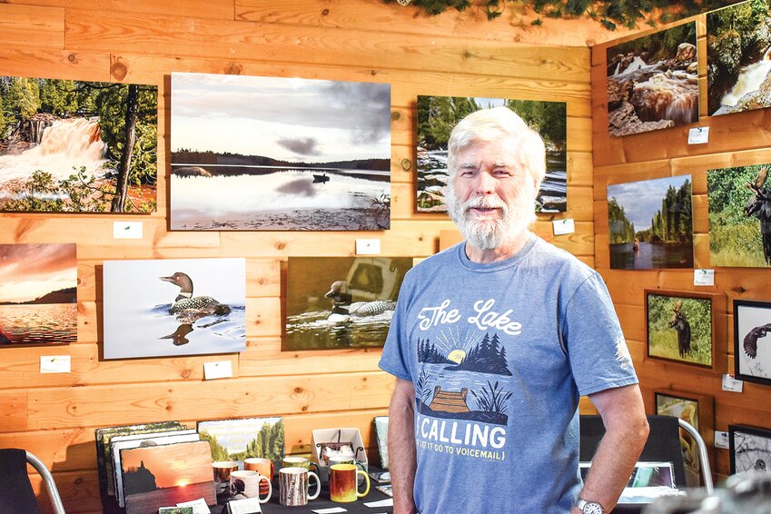 Larry Ricker in front of a display of his work at The Cabin gift shop at 120 E. Sheridan in Ely.