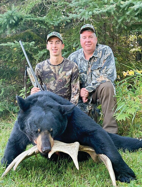 Ben Burns, age 16, and his father Steve pose with the nice bear shot by Ben earlier this month as   clients of the Udovich Guide   Service.