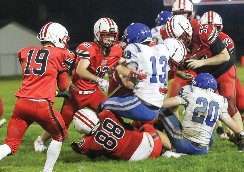 A scrum of Ely   defenders put the hurt on a South Ridge running back during last Friday&rsquo;s home contest.