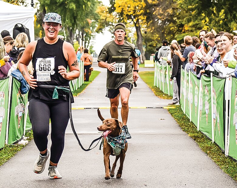 Half   marathon   competitor Allie Aufderheide comes into the finish with her dog. Aufderheide finished in 77th place, but her   companion was the first dog across the finish line on Saturday.