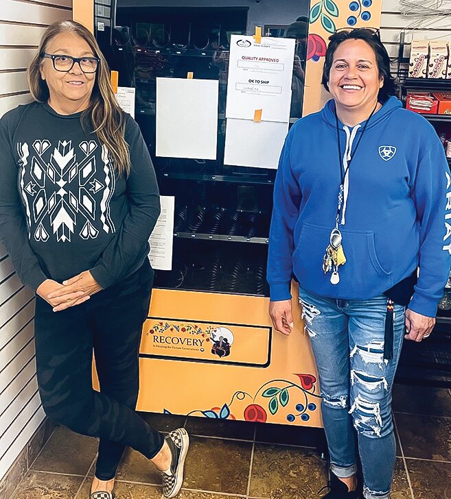 Bois Forte&rsquo;s   Pam Hughes, left, and Toni Wakemup, right, stand by the Public Health Vending Machine at the Nett Lake C Store. The machine at the C Store and Fortune Bay will be filled up and ready to go for the official deployment on Friday, Oct. 6.