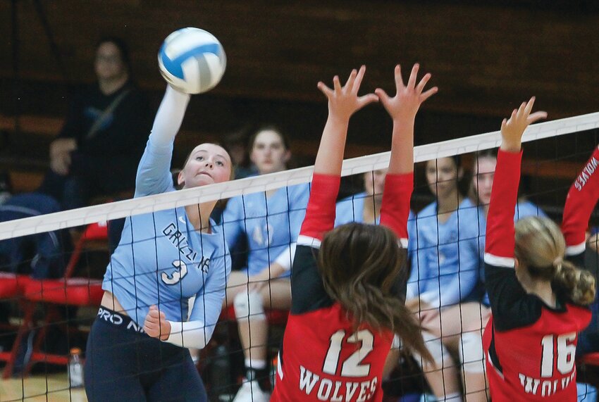 The Grizzlies&rsquo; Lauren Burnett goes up high for a smash attempt as Ely&rsquo;s Lilli Rechichi and Charlotte   Hegman defend.