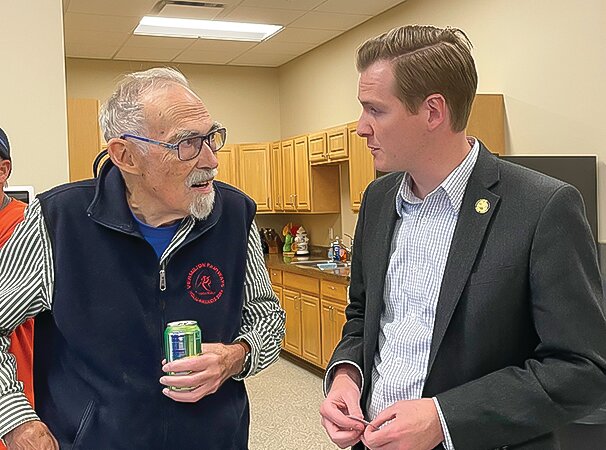 Cook Mayor Harold Johnston speaks with Sen. Grant Hauschild.