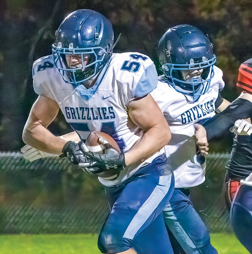 Grizzlies&rsquo;   senior   lineman   Noah   Westman   got the chance to carry the   ball late in the game, taking this handoff   from Trajen Barto.