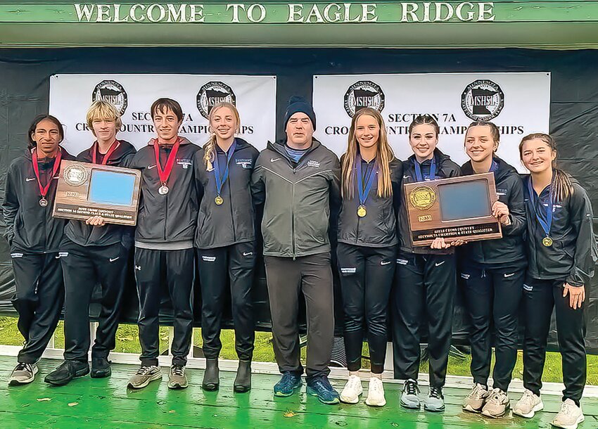 North Woods cross country runners post with their sectional meet plaques to celebrate both boys and girls teams qualifying for the state meet. Pictured are, from left, Kahlil Spears, Lincoln Antikainen, Alex Burckhardt, Corra Brodeen, assistant coach Dan Squires, Zoey Burckhardt, Tatum Barto, Evelyn Brodeen, and Addiston Burckhardt.