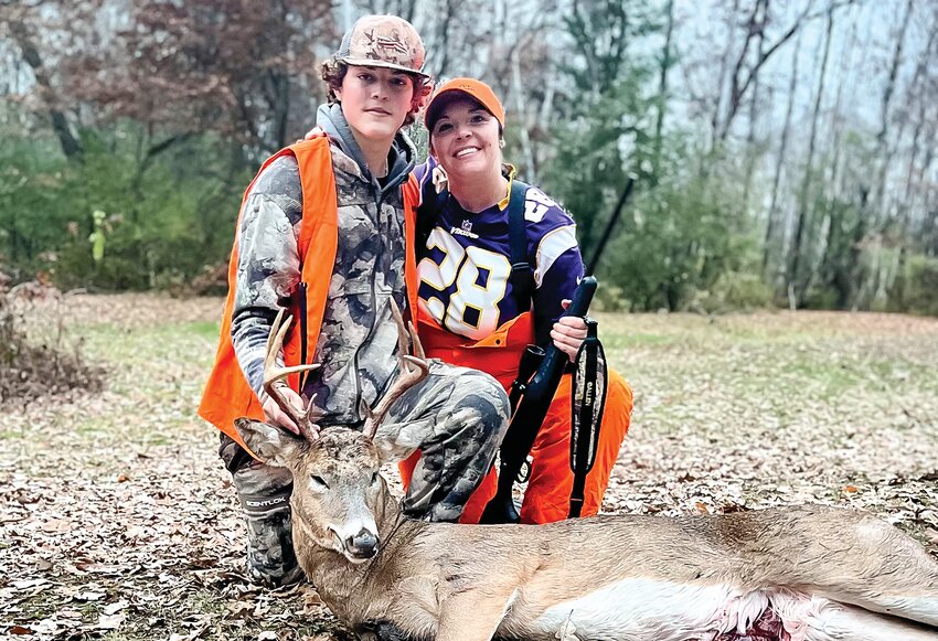 Chessica Reichert, of Lake Vermilion, and her son Jace Olson, pose with the eight-point buck Chessica shot in central Minnesota. It was the first buck Chessica shot in ten years of hunting on the property.  For the first time in years, the Timberjay received no photos from   successful hunters locally.