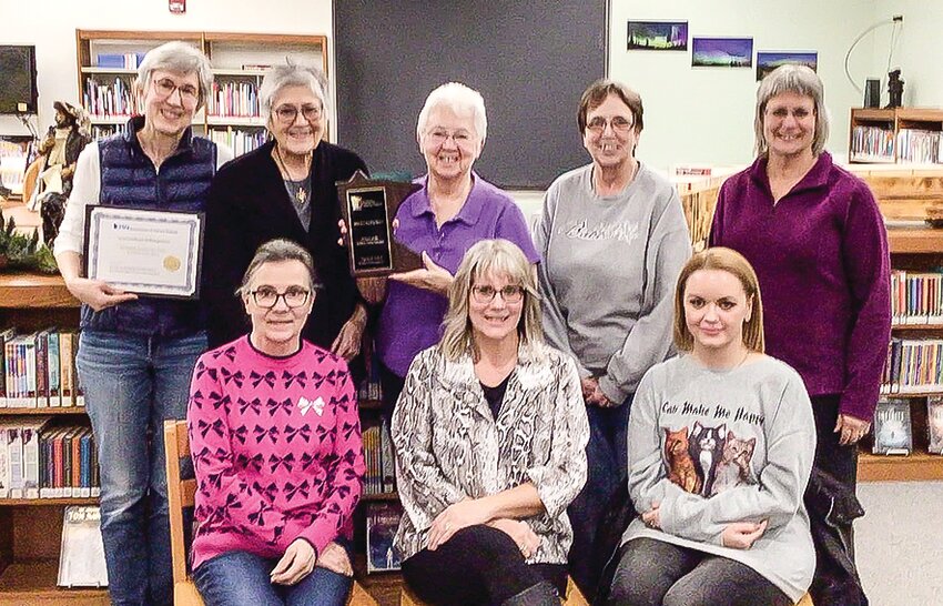 The Friends of the Babbitt Library with the Eva Nordley Award from the Minnesota Association of Library Friends. Left-to-right, back row: Kathleen Graber with the award certificate, Renee Adams, Elaine Postudensek with the award plaque, Carolyn Holm, and Terri Loewen. Front row: assistant librarian Joann Briggs, library director Lisa Pennala, library clerk Jenna Sutter.