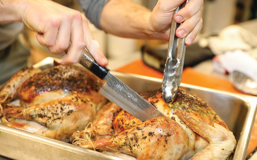 Carving up the fresh-  roasted turkeys just ahead of the Thanksgiving holiday.
