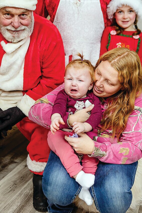 Payslee Olson, with her mother Paige, was not a fan of the man in the big red suit.