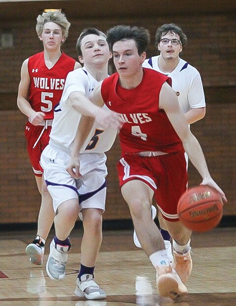 Ely sophomore Jack Davies brings the ball down court