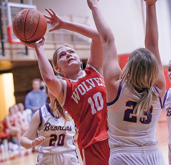 Ely junior Clare Thomas eyes the basket as she lines up a jump shot while under   pressure from a   Broncos&rsquo; defender.