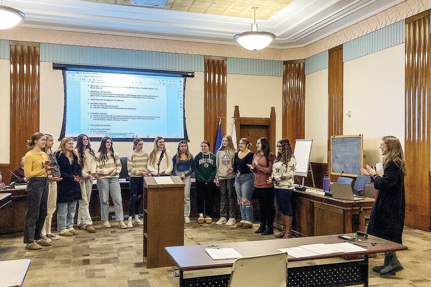 Mayor Heidi Omerza (far right) read a proclamation to the Ely Memorial High School girls   volleyball team at the Dec. 19 city council meeting, awarding the team the key to the city for   their achievements over the last two years.