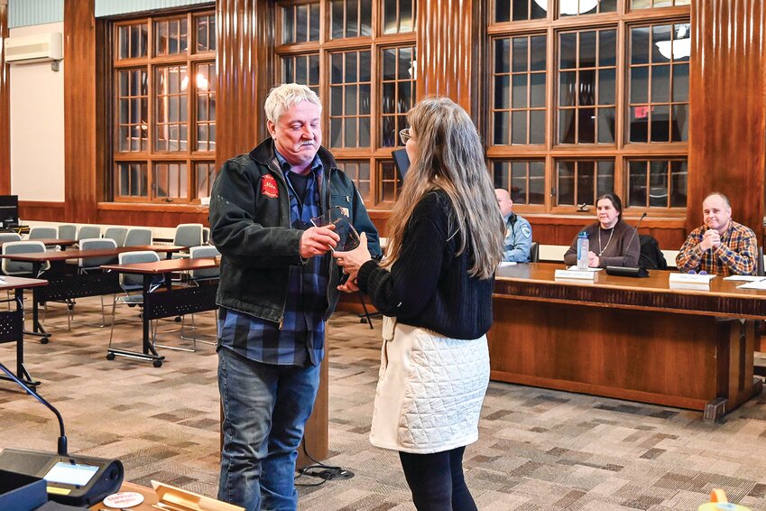 Public Works Foreman Mike Popesh received a commemorative plaque from Mayor Heidi Omerza in honor of his more than 43 years of service to the city of Ely at Tuesday&rsquo;s city council meeting. Popesh retired last week. He started working for the city at the end of 1980.
