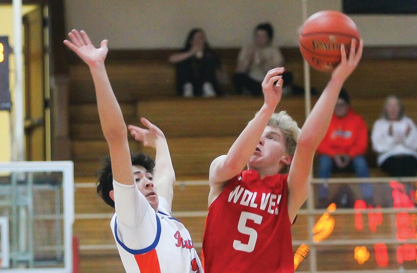 Ely sophomore  Drew Johnson   goes up for a jump shot against a Wrenshall defender.