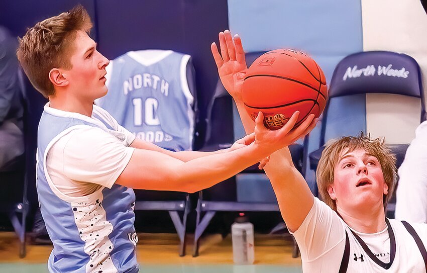North Woods   senior Jonah Burnett&rsquo;s shot against Mesabi East frames the No. 10 jersey of senior Tra&rsquo;von Boshey in the   background. Boshey  was honored along with the team&rsquo;s four other seniors for senior night.