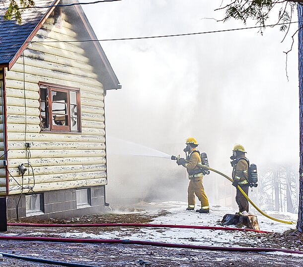 Morse-Fall Lake firefighters work to douse the blaze at the home of Carol Lindbeck, of rural Ely.