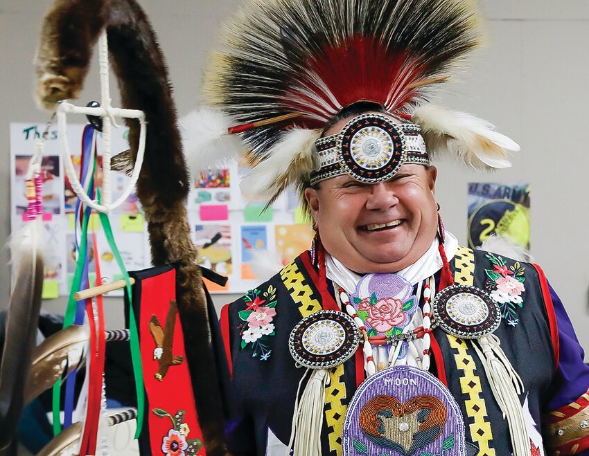 Curt Moon, in full regalia, leads dancers during a powwow last Friday at Vermilion Country School in Tower. The powwow was educational in nature and   provided students with details behind the tradition and the many styles used by dancers.
