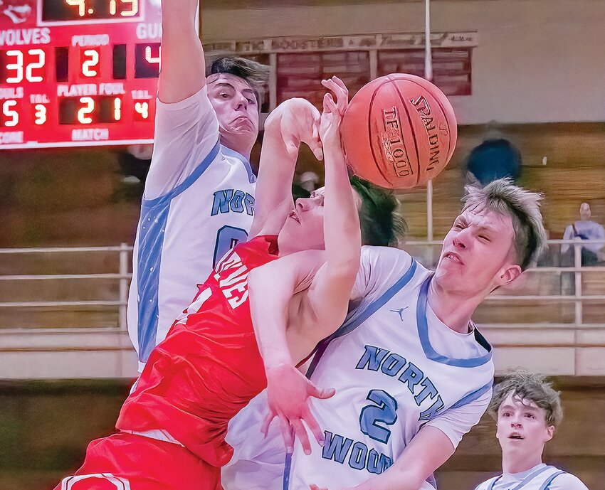 The Grizzlies&rsquo; Evan Kajala skies high to protect the basket as teammate Luke Will wraps up Ely&rsquo;s Jack Davies as he attempts a jumper.