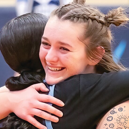 North Woods   senior River Cheney is all smiles as she hugs a teammate after scoring her 1,000th career point against Bigfork.