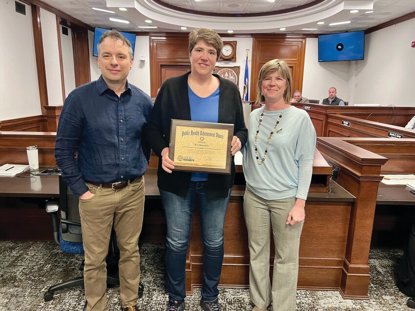 The county board presented a Public Health Achievement Award to Teri Morrison, the Community Health Program Manager at Bois Forte Health and Human Services on Tuesday. She is shown (center) with commissioner Patrick Boyle and St. Louis County Public Health Division Director Amy Westbrook.