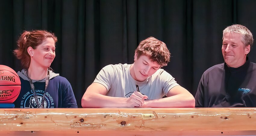 Flanked by his mother, Jenny, and father, Tom, North Woods senior Jonah Burnett signs a letter of intent to play basketball for the University of Northwestern-St. Paul   Eagles next year.