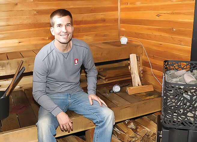 Lamppa Manufacturing CEO Garrett Lamppa   poses in one of the test saunas at the company&rsquo;s headquarters in Tower.