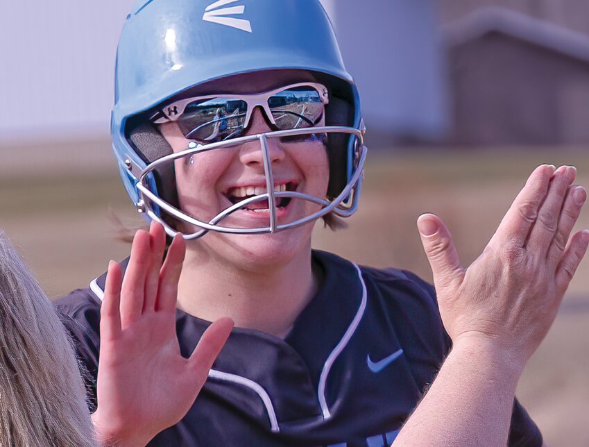 Grizzlies&rsquo; senior cleanup hitter River Cheney is all smiles as she gets a high five from Head Coach Dee Ann Sandberg after blasting a three-run homer on Monday.