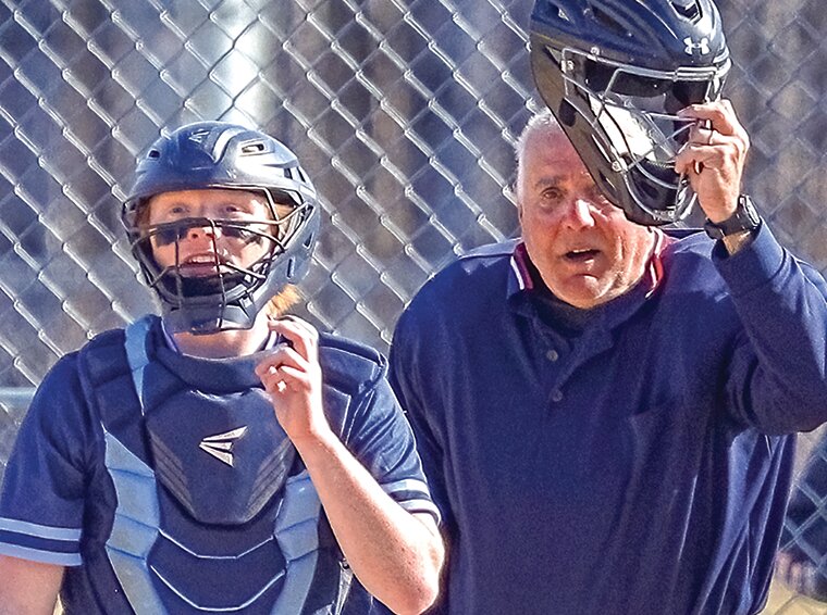 North Woods catcher Louie Panichi has an anxious look on his face as he and umpire Mike Turnbull track the flight of a deep fly ball   hit by a Mesabi East batter   in an April 25 game at North Woods. The  Grizzlies lost 11-0.