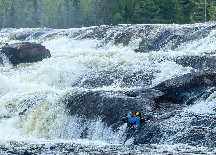 A St. Louis County Sheriff&rsquo;s Office Rescue Squad member inspecting a &ldquo;drill hole&rdquo; in the turbulent Curtain Falls, which forms part of the American-Canadian border in the Boundary Waters Canoe Area Wilderness.
