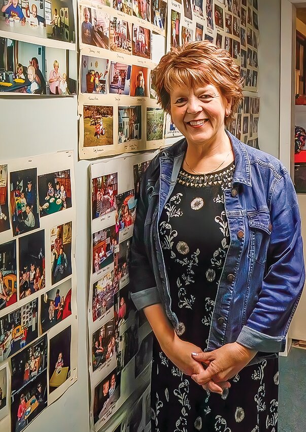 Nancy Reing standS in a hallway of memories of children she&rsquo;s cared for at Little Beginnings.