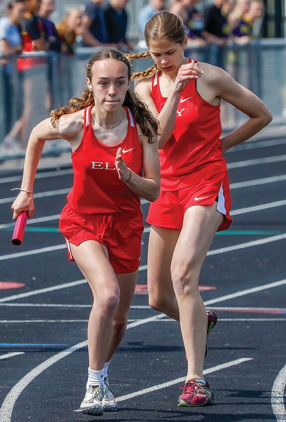 Ely&rsquo;s Molly Brophy looks focused as she takes the handoff from Lydia Schultz in the 4x400 relay event.