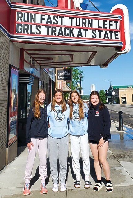 Ely&rsquo;s 4x400 relay runners pose under the marquee at the State Theater in Ely before heading off to the state track meet.