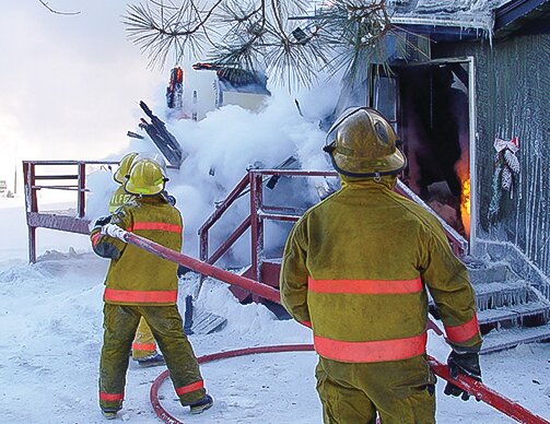 Volunteer firefighters from Vermilion Lake fight a cabin blaze. Small volunteer departments could be   impacted by proposed new regulations.